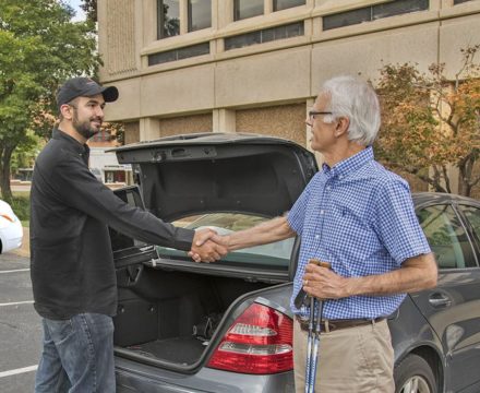 Christian shaking a man's hand